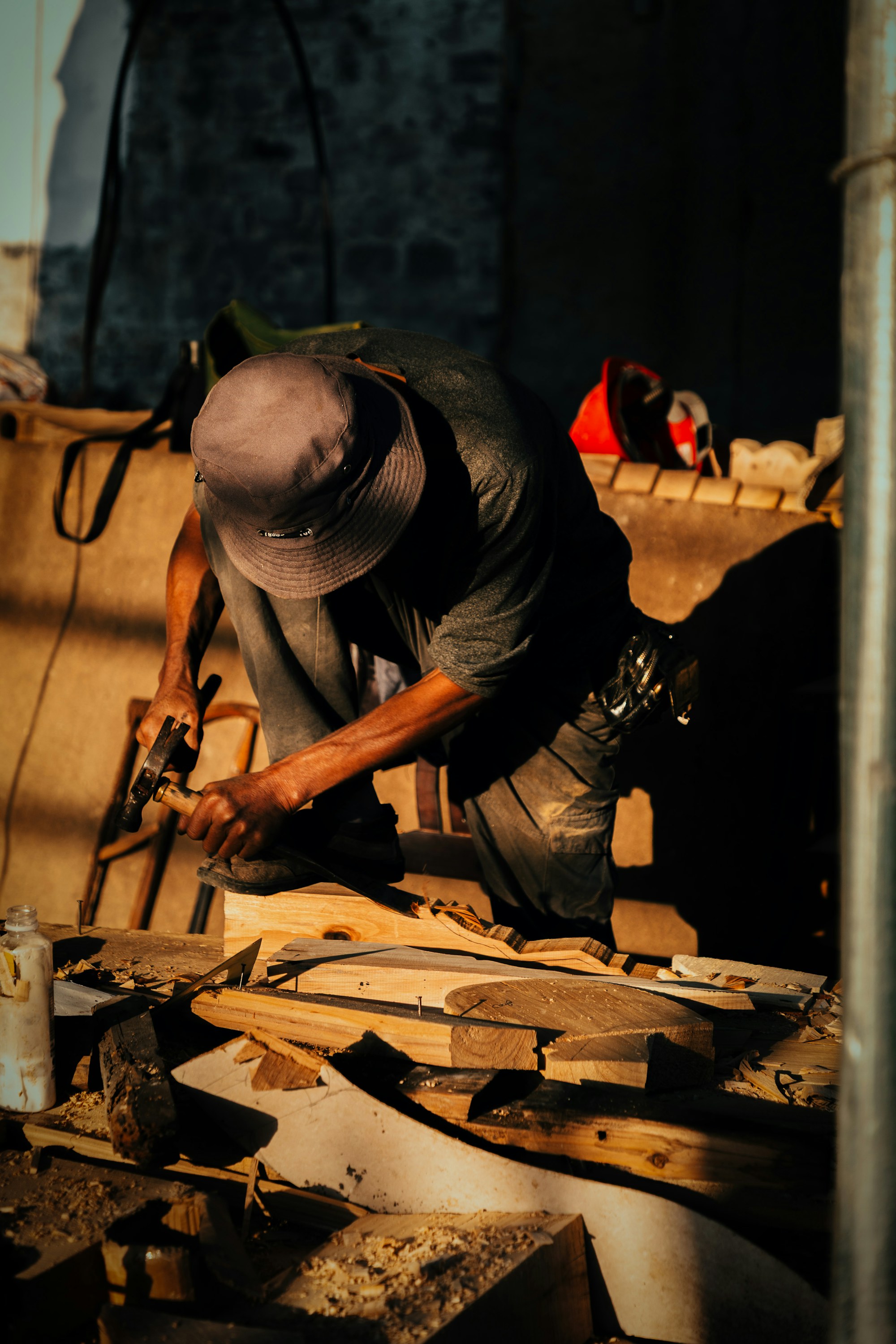 A furniture maker working carefully at a timber bench